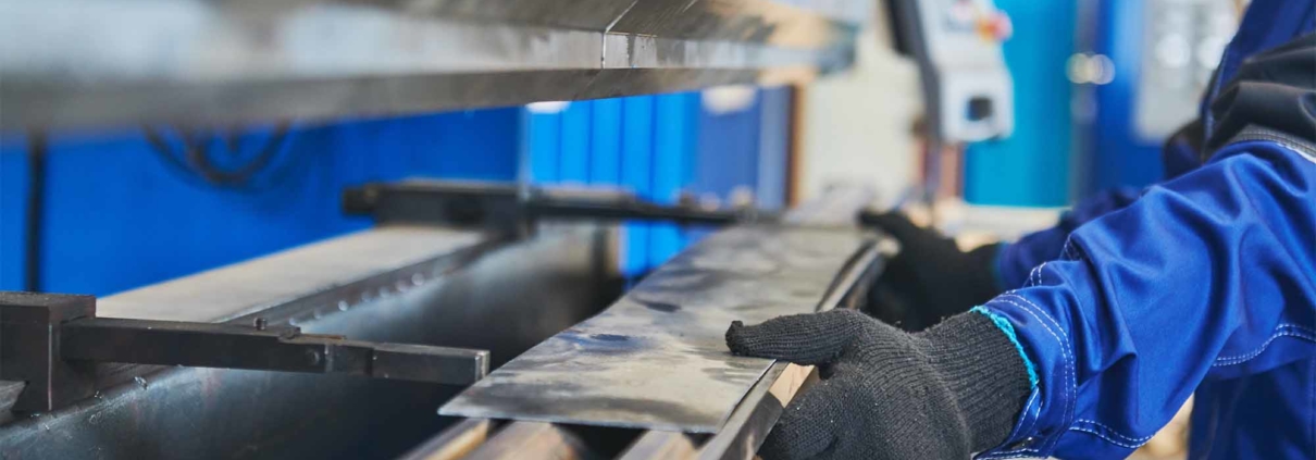 person using machine to cut sheet metal