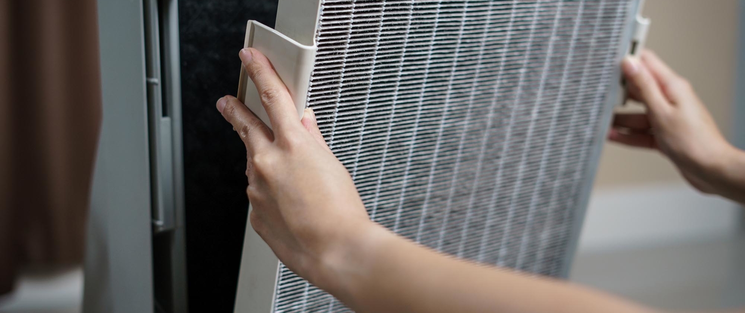 HVAC worker changing out large filter