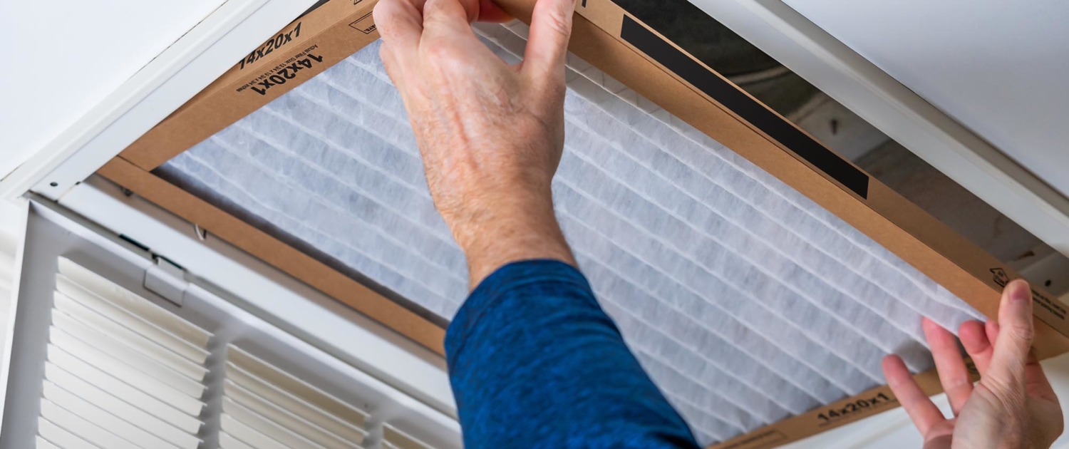 HVAC worker swapping out a dirty air filter